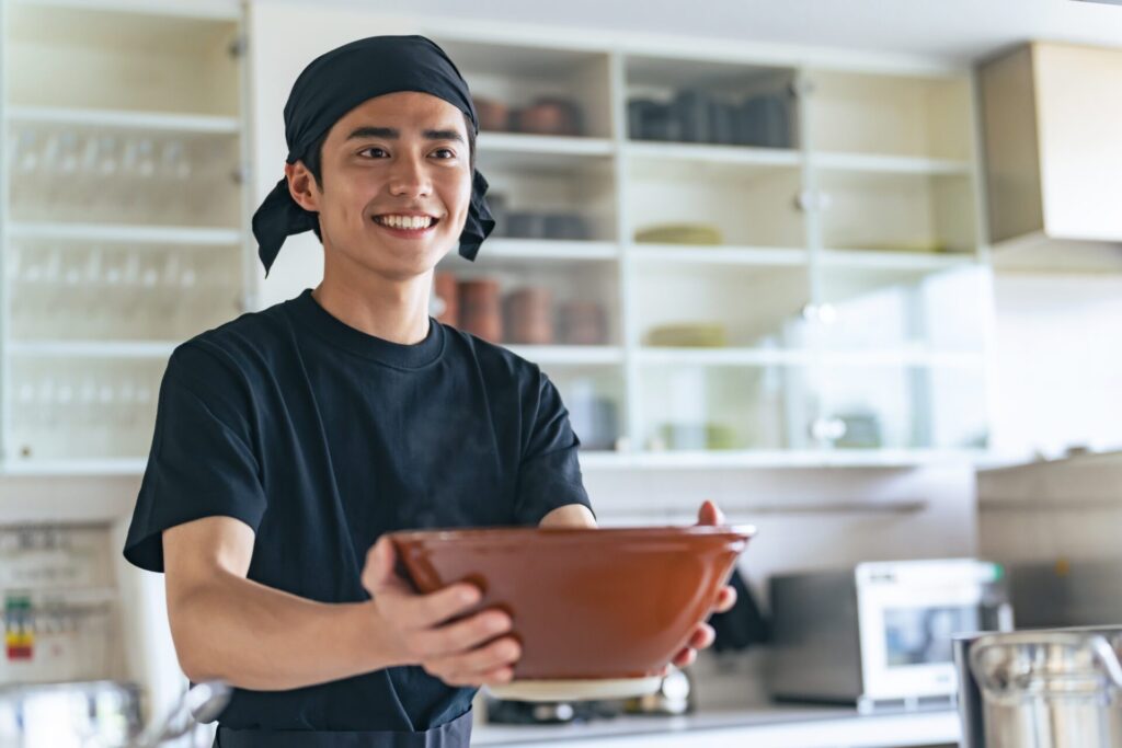 A,Ramen,Shop,Clerk,Offering,A,Bowl.